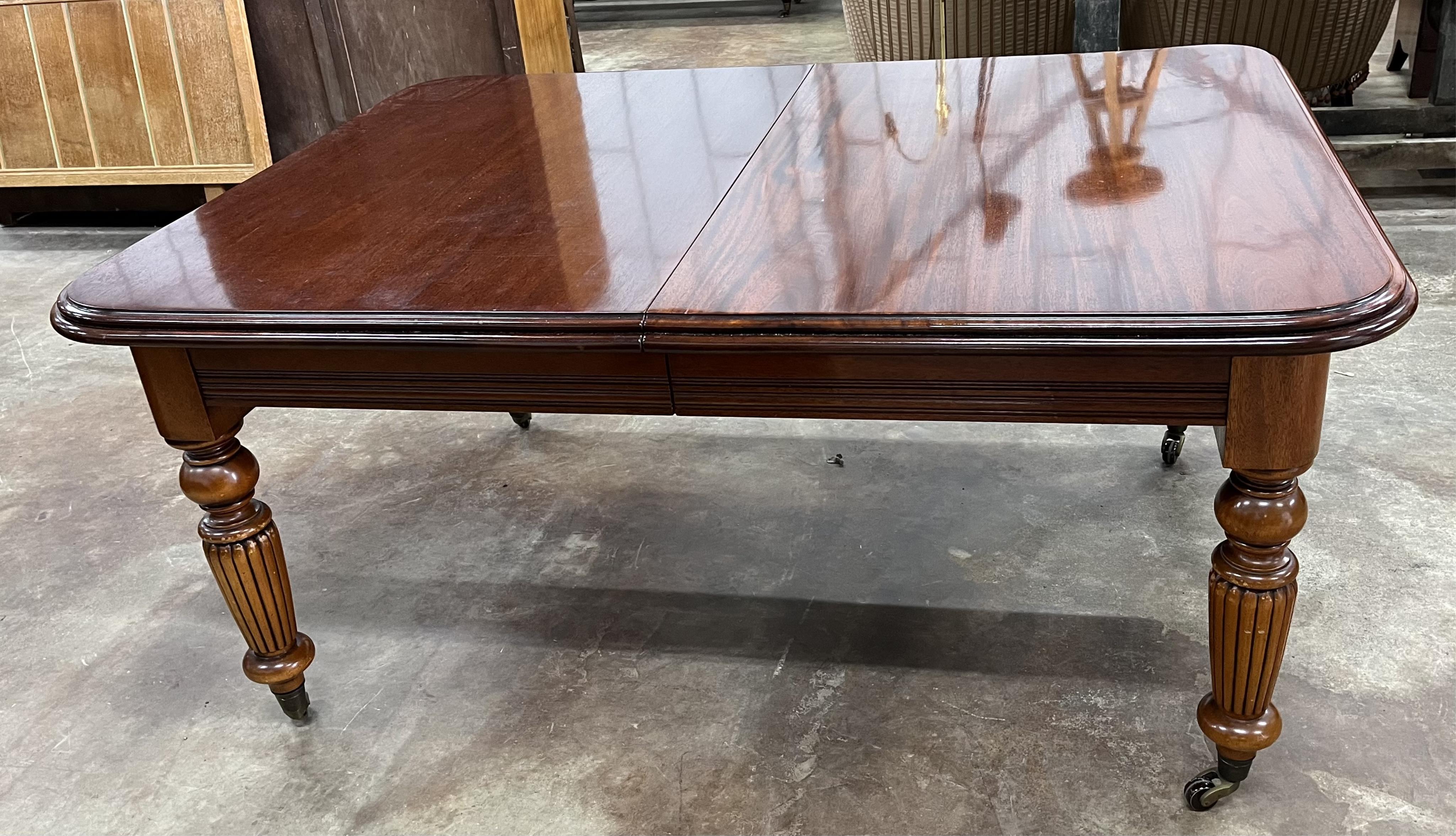 A reproduction Victorian style mahogany extending dining table, 310cm extended, three spare leaves, depth 123cm, height 79cm. Condition - fair to good